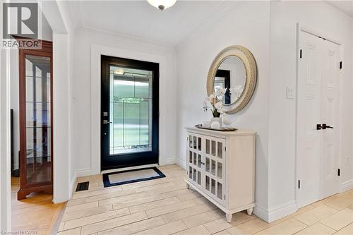 Entryway featuring a decorative transom door, light-toned tile flooring, and crisp white walls - 7 Shadywood Lane, Cambridge, ON 