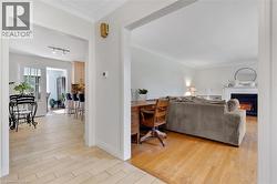 Hardwood flooring, crown molding, fireplace with mantel, French doors, and tile flooring - 
