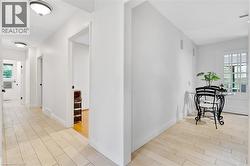 Light-toned flooring throughout, white walls, and recessed lighting fixtures - 