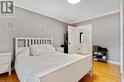 Hardwood flooring, crown molding, white trim, recessed wall speakers, and solid core doors - 