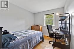 Hardwood-style flooring, white trim window, light gray wall finishes, and a built-in wood dresser - 