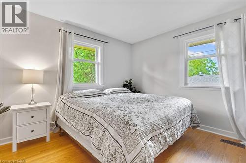 Hardwood flooring, two windows, and white walls - 7 Shadywood Lane, Cambridge, ON 