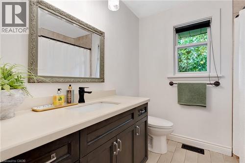 Dark wood-finish vanity with a light-toned countertop and an undermount sink - 7 Shadywood Lane, Cambridge, ON 
