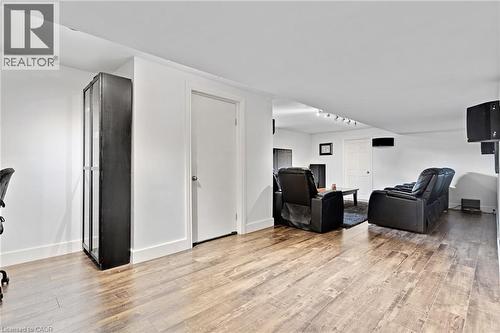 Recessed lighting, wood-finish flooring, white walls, and a built-in display cabinet - 7 Shadywood Lane, Cambridge, ON 