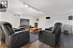 Recessed window, wood-finish flooring, white walls, and track lighting fixtures - 