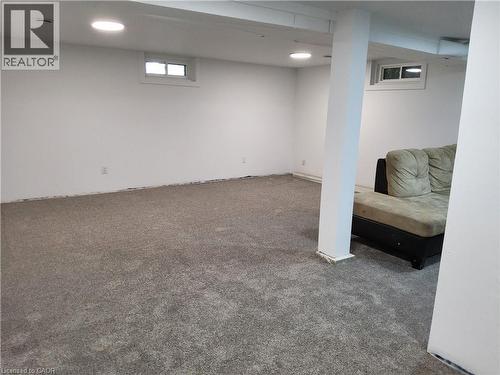 Recessed lighting, painted white walls, gray carpet, and two egress windows - 33 Lee Avenue, Simcoe, ON 