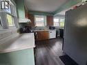 Wood-finish flooring, multiple windows, built-in cabinetry, and a range hood - 33 Lee Avenue, Simcoe, ON 