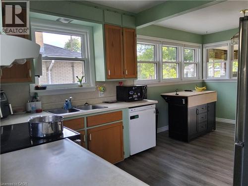 Recessed lighting, wood-finish flooring, multiple windows, built-in cabinetry, and a kitchen island with a wood-finish top - 33 Lee Avenue, Simcoe, ON 