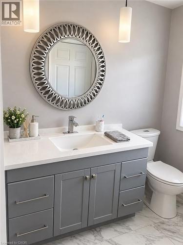 Vanity with gray cabinetry, white countertop, and an integrated rectangular sink - 73 Larkspur Crescent, Kitchener, ON 