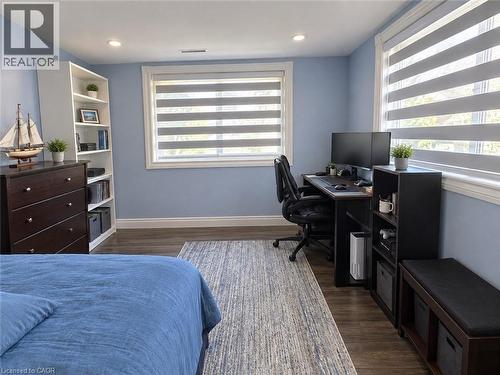 Recessed lighting, wood-finish flooring, white window trim, and dual windows with blinds - 73 Larkspur Crescent, Kitchener, ON 