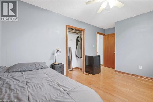 Wood-finish flooring, ceiling fan, and light blue wall finish - 76 Madeira Crescent, Cambridge, ON 