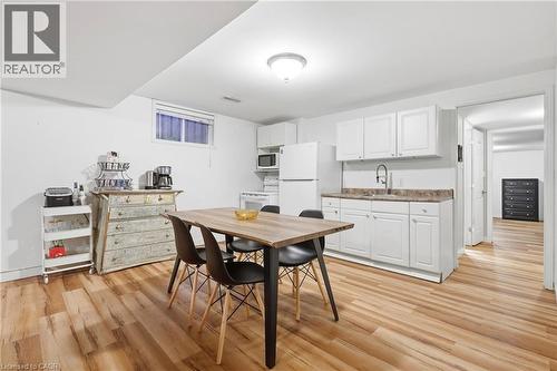 Full kitchen with white cabinetry, countertop, and a stainless steel sink - 76 Madeira Crescent, Cambridge, ON 