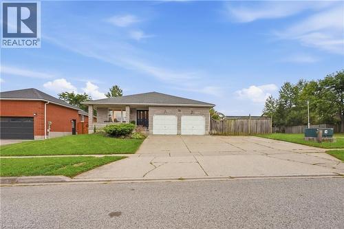 Single-story residence featuring a brick exterior and a two-car garage - 76 Madeira Crescent, Cambridge, ON 