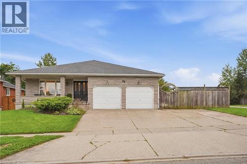 Stone veneer exterior with a covered front porch, double garage, asphalt shingle roof, and a concrete driveway - 76 Madeira Crescent, Cambridge, ON 