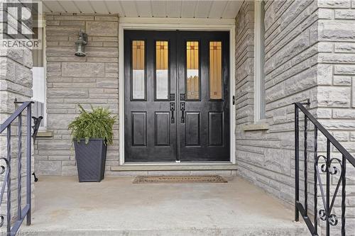 Double entry doors with decorative glass panels, stone veneer facade, and wrought iron handrails - 76 Madeira Crescent, Cambridge, ON 