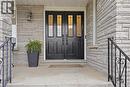 Double entry doors with decorative glass panels, stone veneer facade, and wrought iron handrails - 76 Madeira Crescent, Cambridge, ON 