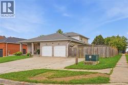 Stone facade, two-car garage, covered entry, mature privacy fence, paved driveway - 