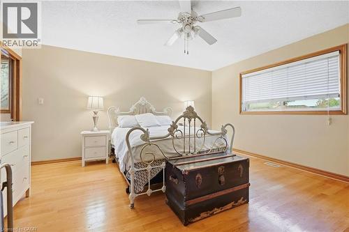 Hardwood flooring throughout, ceiling fan, and window with wood trim - 76 Madeira Crescent, Cambridge, ON 