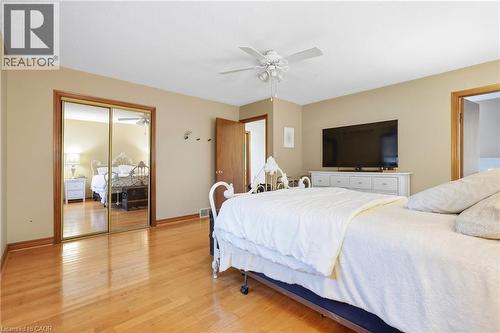 Hardwood flooring, mirrored closet doors, ceiling fan with integrated lighting, and neutral wall tones - 76 Madeira Crescent, Cambridge, ON 
