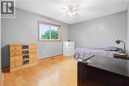 Light gray walls, wood-finish flooring, and a ceiling fan with light fixture - 76 Madeira Crescent, Cambridge, ON 
