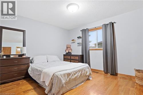 Hardwood flooring, painted walls, and window with wood trim - 76 Madeira Crescent, Cambridge, ON 