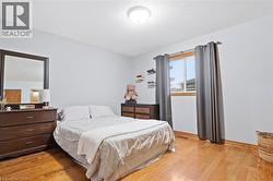 Hardwood flooring, painted walls, and window with wood trim - 