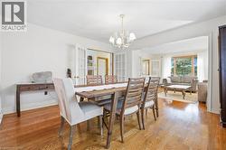 Hardwood flooring throughout, white walls, and a chandelier lighting fixture - 