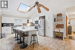 Vaulted ceiling with skylight and ceiling fan - 