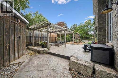 Stamped concrete patio with a wood pergola, stone accents. - 112 Margaret Avenue N, Waterloo, ON 