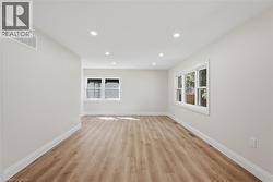 Recessed lighting illuminates wood-finish flooring - 