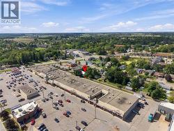 Commercial building with extensive paved parking, multiple storefronts, and a loading dock area - 