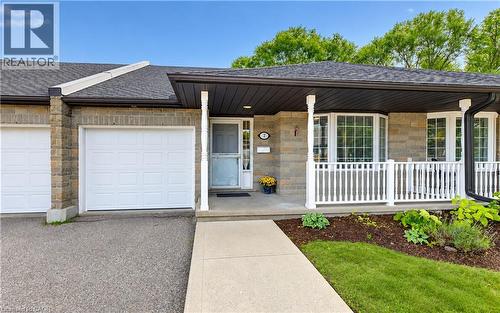 Stone facade, covered front porch, white railing, bay window, attached garage - 25 Bankside Drive Unit# 2, Kitchener, ON 