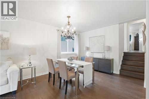 Hardwood-style flooring throughout, crown molding, and a chandelier with a polished finish - 22 Sycamore Street, Hamilton, ON 