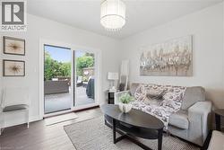 Wood-finish flooring, sliding glass patio doors, and a decorative ceiling fixture - 