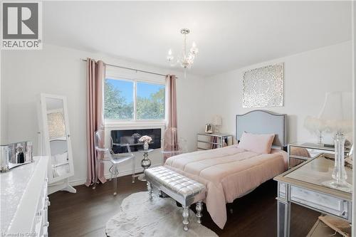Recessed window featuring a built-in shelf, dark wood-finish flooring, and white walls - 22 Sycamore Street, Hamilton, ON 