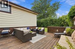 Expansive wood deck with a privacy fence and mature hedge - 