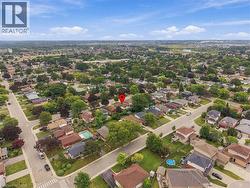 Aerial overview of a residential neighborhood with established streetscapes and mature tree canopy - 