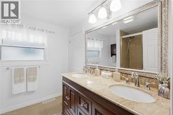 Dual vanity featuring undermount sinks, chrome fixtures, and a light-toned countertop - 