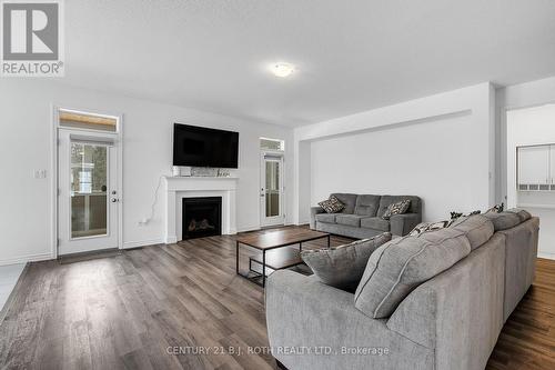 Family Room with FP & Dual Access to Muskoka Room - 22 Dyer Crescent, Bracebridge, ON 