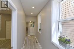 Recessed lighting illuminates wood-finish flooring - 