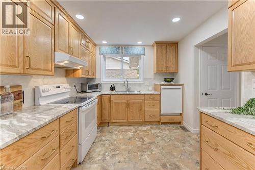 Kitchen featuring wood cabinetry, light-toned countertops, a built-in dishwasher, and recessed lighting - 422 Grangewood Drive, Waterloo, ON 