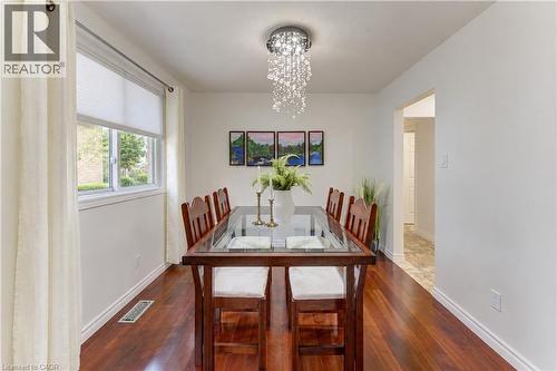 Hardwood-finish flooring, white walls, and a multi-pane window with cellular shades - 422 Grangewood Drive, Waterloo, ON 