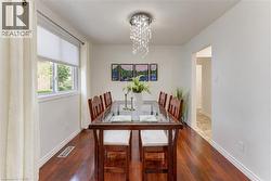 Hardwood-finish flooring, white walls, and a multi-pane window with cellular shades - 