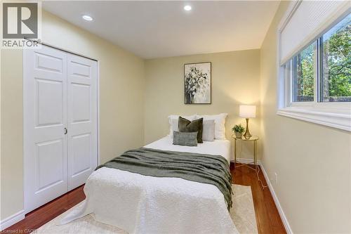 Recessed lighting, wood-finish flooring, white window trim, and a built-in closet with bi-fold doors - 422 Grangewood Drive, Waterloo, ON 