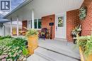 Brick exterior with white trim, covered front porch, concrete steps, and a bay window - 422 Grangewood Drive, Waterloo, ON 