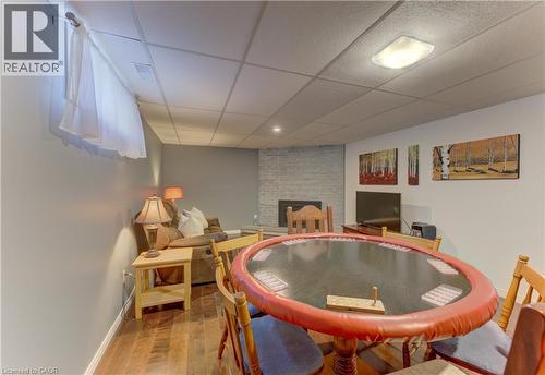 Wood-finish flooring throughout, featuring a stone-clad fireplace and recessed lighting - 422 Grangewood Drive, Waterloo, ON 