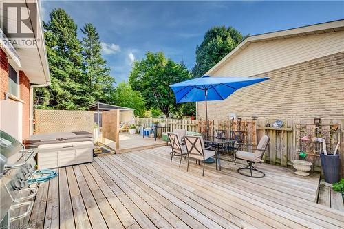Expansive wood deck with a hot tub, a pergola, and a privacy screen - 422 Grangewood Drive, Waterloo, ON 