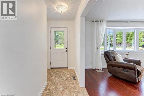 Entryway featuring a decorative semi-flush mount light fixture, a white door with a leaded glass insert, and durable flooring - 422 Grangewood Drive, Waterloo, ON 