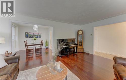 Rich wood-finish flooring extends through the main living areas, complemented by white walls and trim - 422 Grangewood Drive, Waterloo, ON 