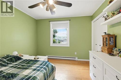 Wood-finish flooring, single window, baseboard heating, ceiling fan, and built-in closet - 1311 W Concession 6 Road, Flamborough, ON 